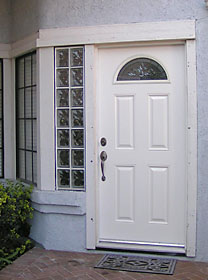 Vertical glass block window by entry door.